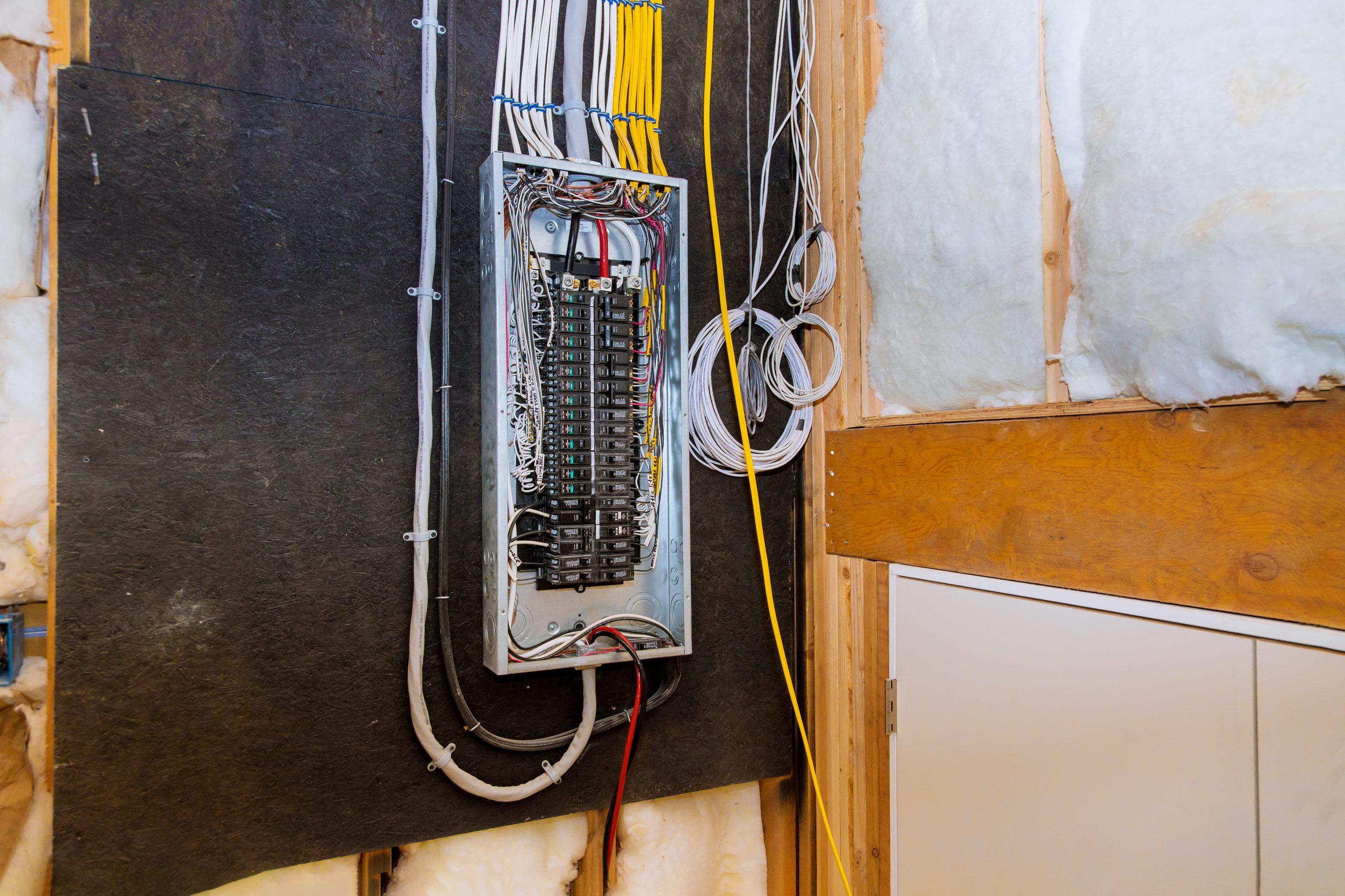 Open electrical panel with visible wiring during an electrical panel replacement in a U.S. residential home.
