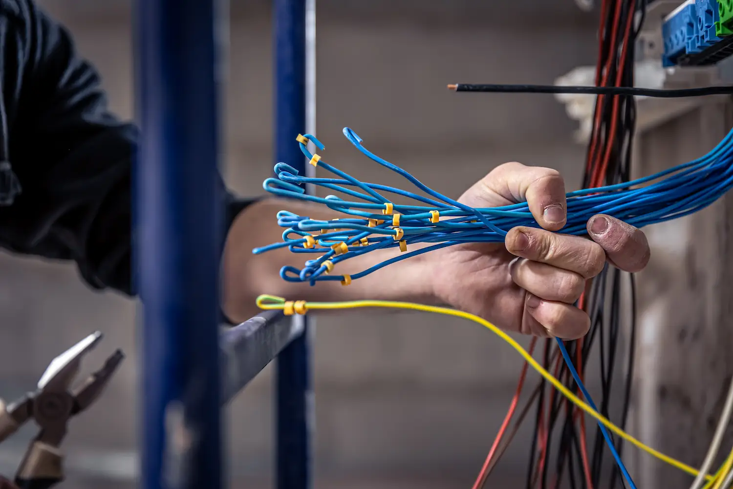 Licensed electrician preparing electrical wiring during professional installation service